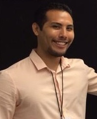 Ernie wearing a cream button-up shirt and smiling.